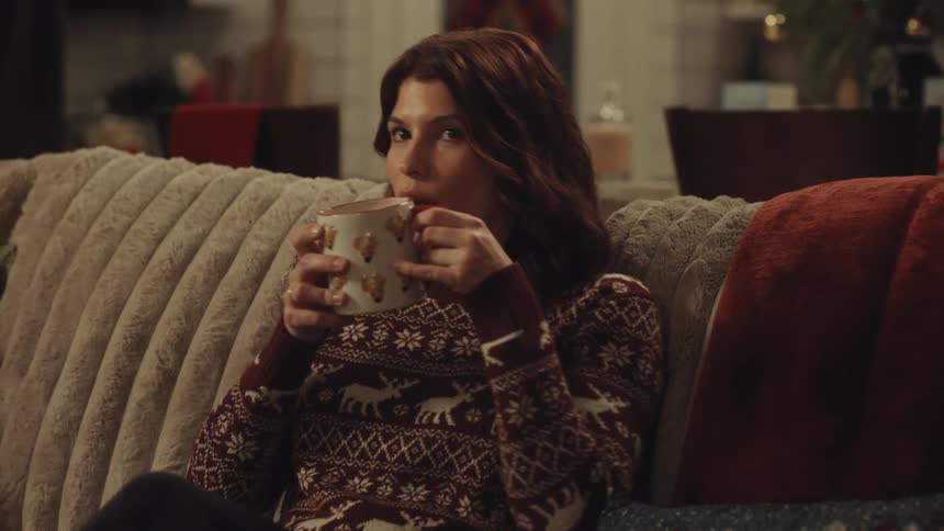 A woman sitting down on a couch