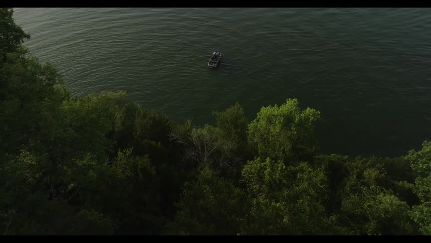 An aerial view of a boat on a lake