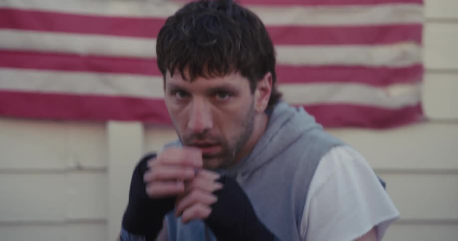Boxer in training stance in front of american flag