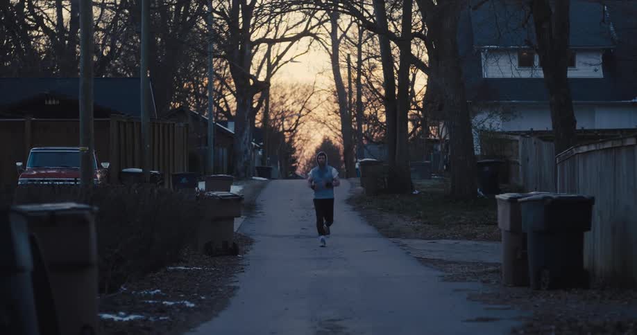 A man running down a street at dawn