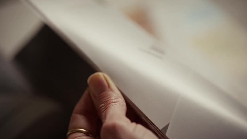 A person reading a magazine in a room