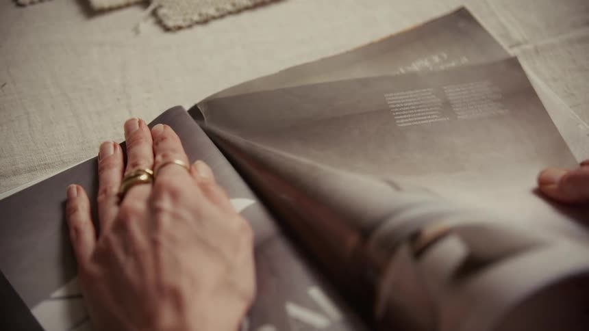 A woman tearing pages out of a magazine