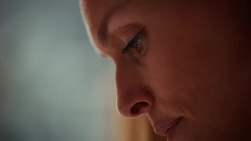 Woman in side profile with gaze directed downward