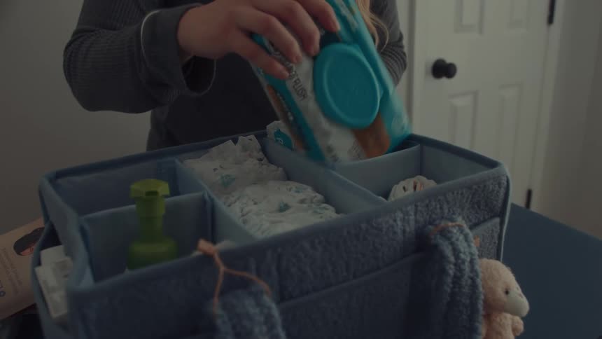 A woman packing items into a bag