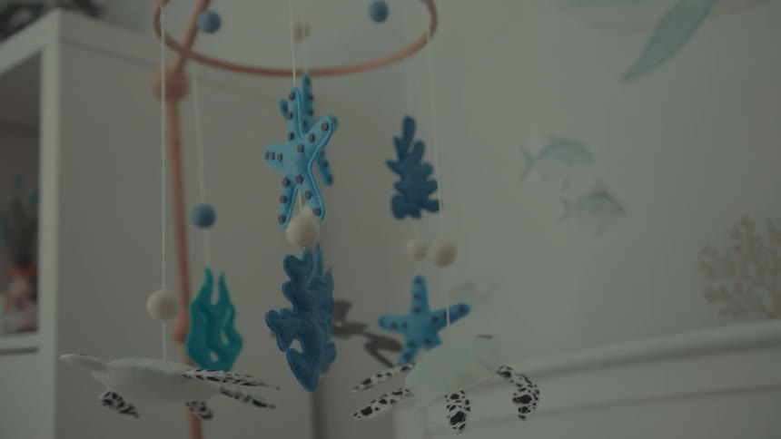 Oceanthemed baby mobile in nursery room