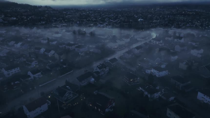 An aerial view of a quiet neighborhood shrouded in a thick lowlying fog during the blue houras the camera tilts upward the misty suburban streets give way to a vast horizon where heavy clouds meet the soft glow of a breaking dawn