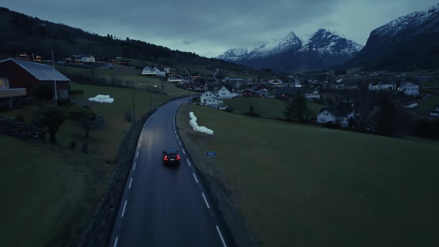 Mountain village at dusk with lit road