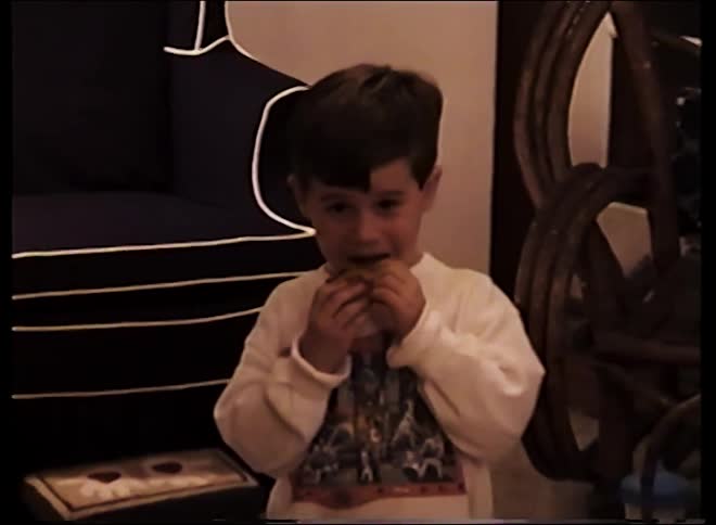 Child holding food in indoor setting