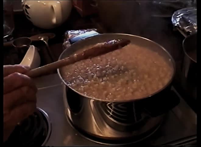 A man cooking food on a stove