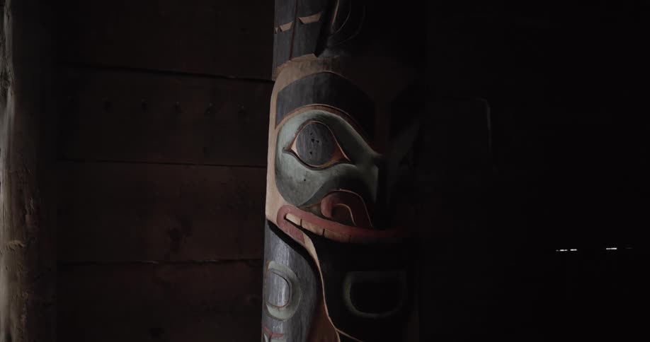 Wooden carved totem inside a dimly lit interior