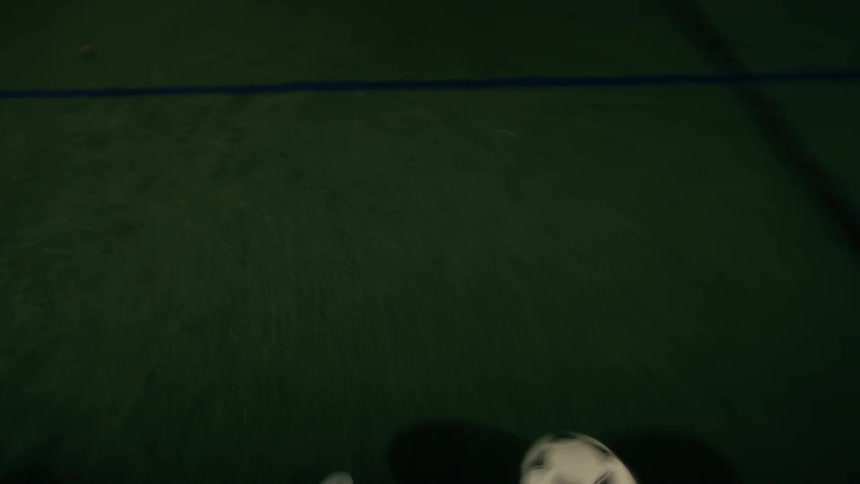 Person playing soccer at night