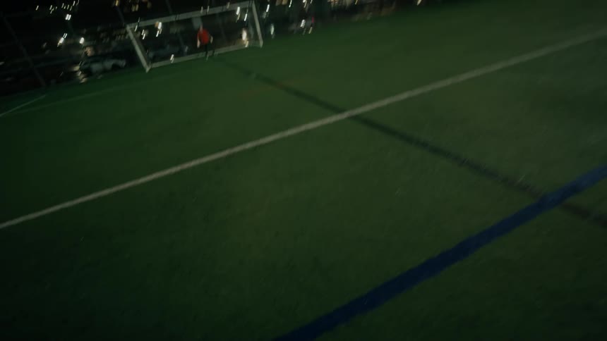 Soccer player kicks the ball towards the goal
