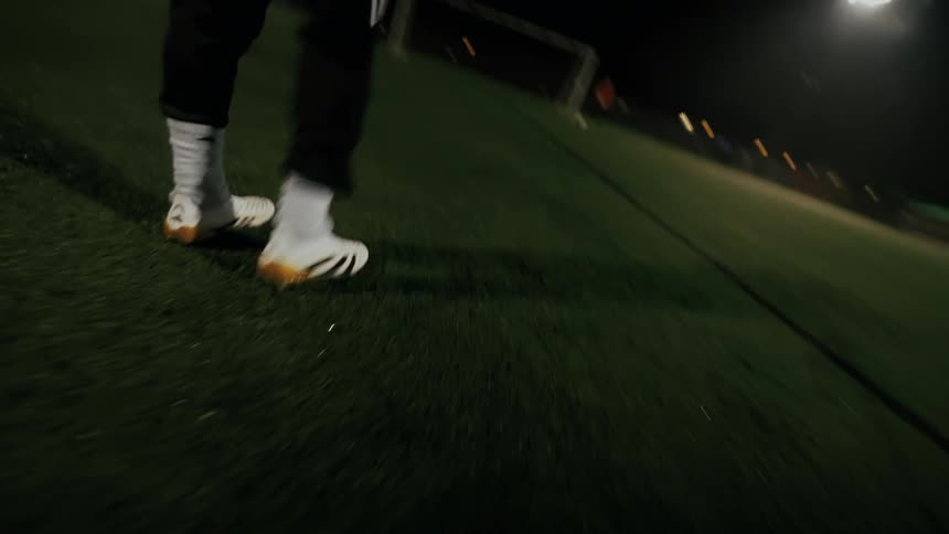 Player kicking a soccer ball towards the goalkeeper