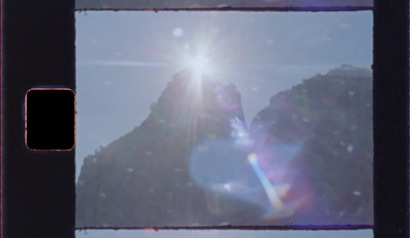 A view of a cliff and the sun behind it