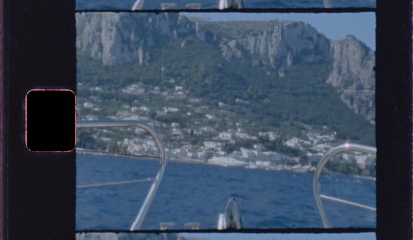Coastal town at the foot of mountains seen from a boat