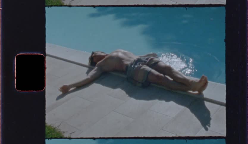 A man laying next to a pool