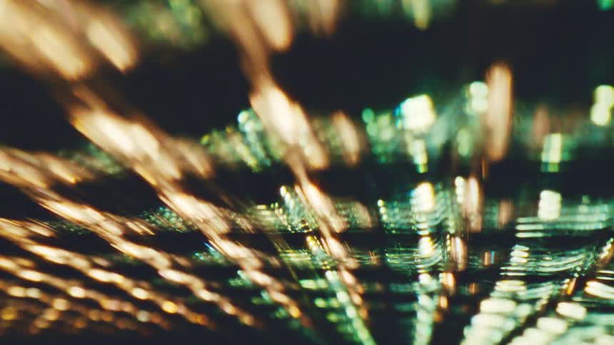 Blurred golden lights forming diagonal lines against a dark background