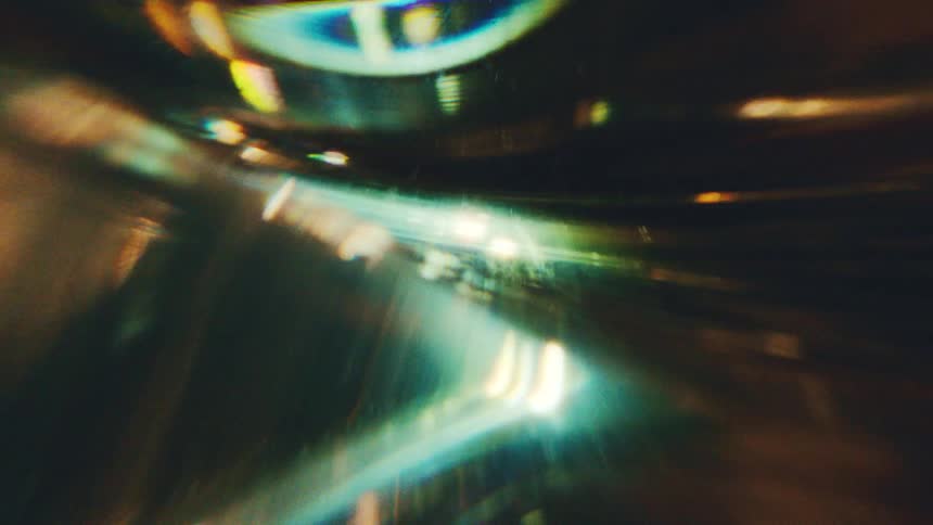 Curved green and golden lines with light points in a dynamic abstract composition