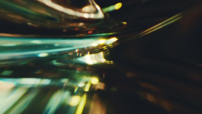 Curved green and golden lines with light points in a dynamic abstract composition