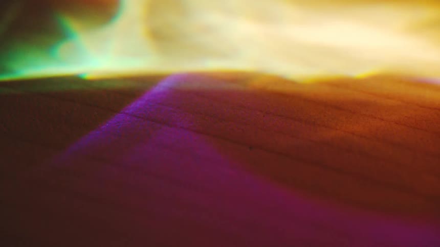 Colorful reflections forming abstract patterns on a textured surface