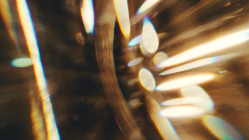 Circular structure with golden reflections and light points in an abstract composition