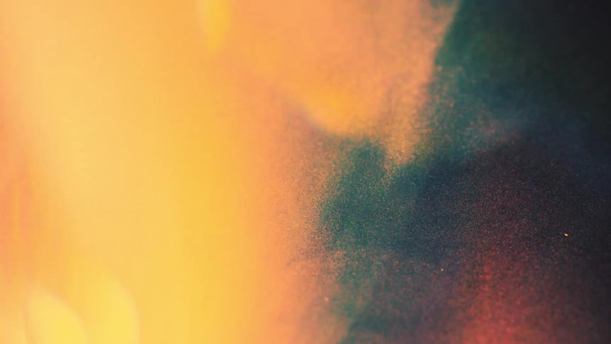 Bright orange lights contrast with a black and green background