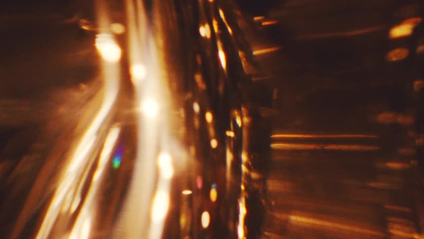 Light shines and refracts through glassy shapes with a golden hue