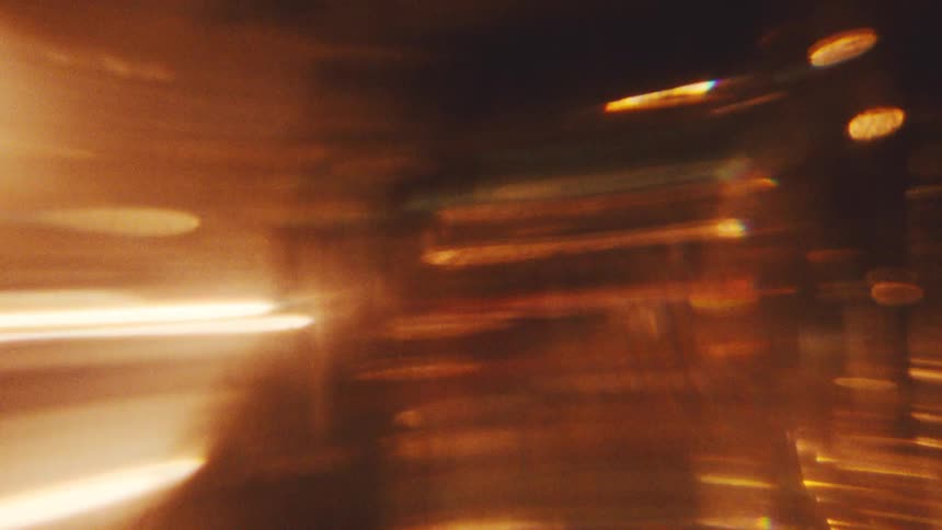 Light shines and refracts through glassy shapes with a golden hue