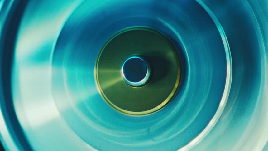 Blue metallic disc spinning with a highlighted circular center