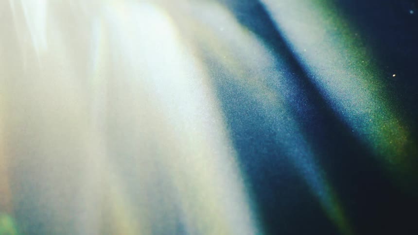 Light beams passing through suspended particles in a dark environment