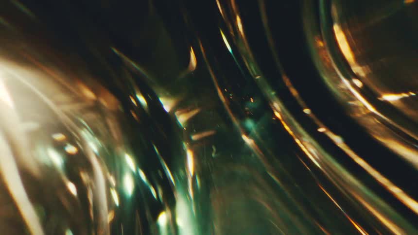Curved green and golden lines with light points in an abstract composition