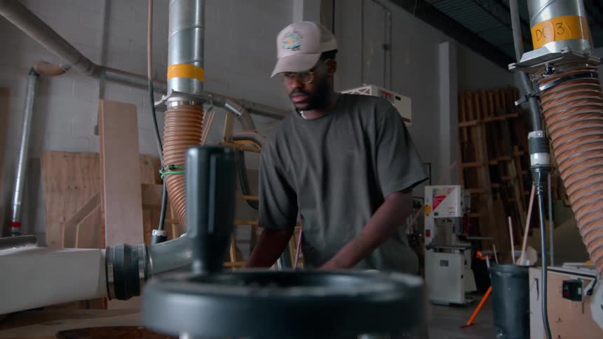 Man works with wood in a workshop