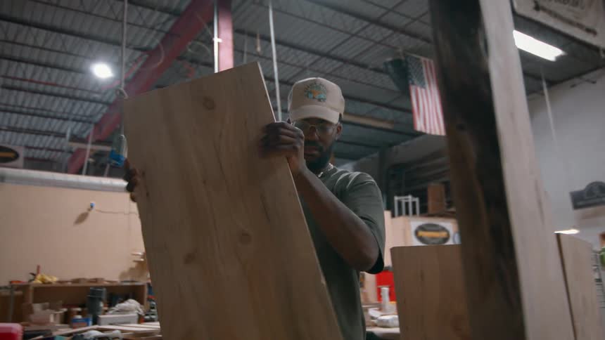 Man builds with wood in a large building