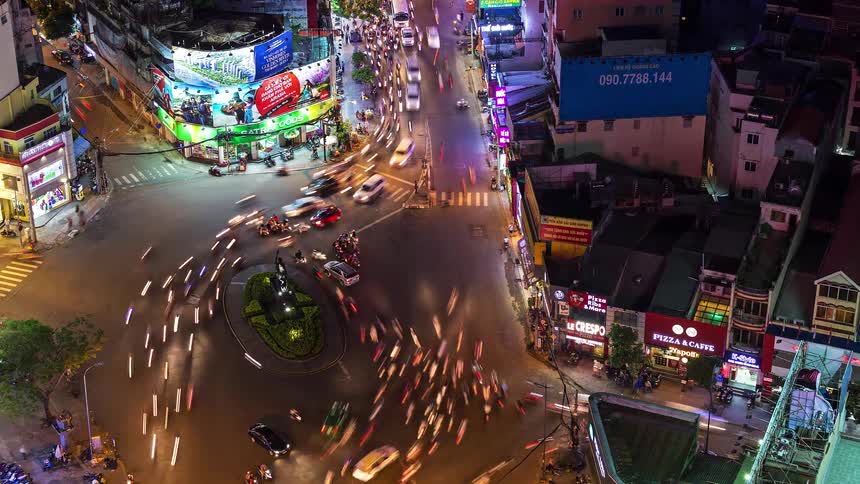 A time lapse of a busy city roundabout shows countless vehicles pass around it