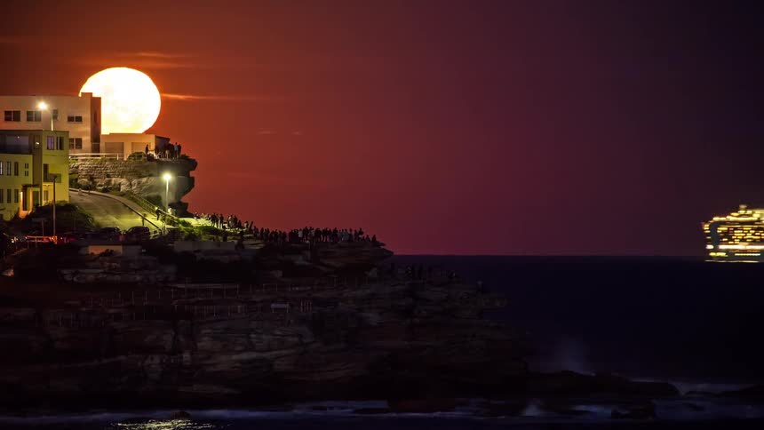 The cruise ship passes the people on the shore