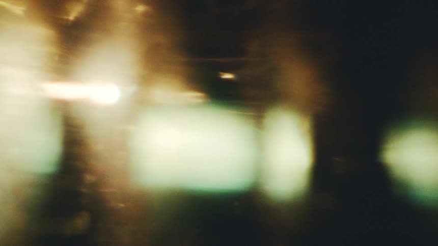 Blurred lights in golden and greenish tones forming abstract composition