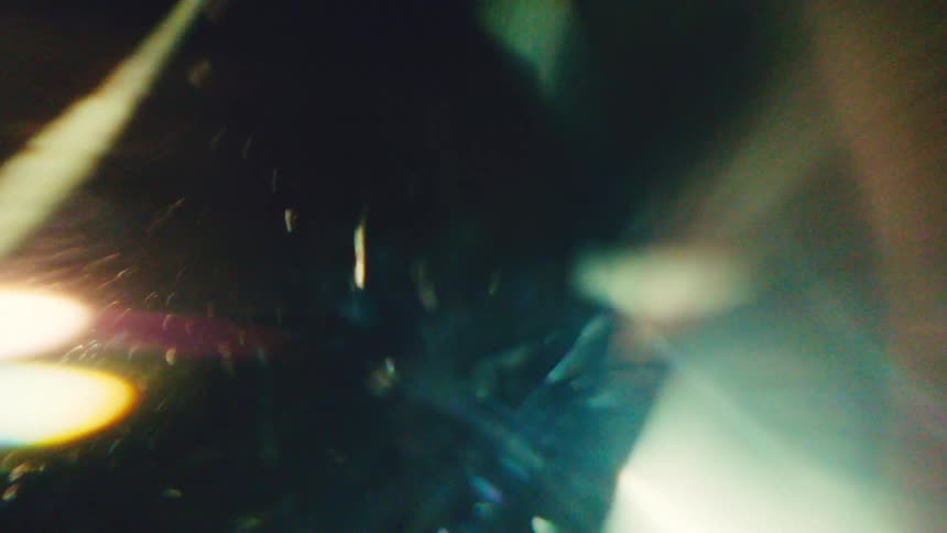 A golden ring spins rapidly at night illuminated by a bright light