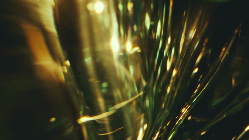 Glass structure with reflections and highlights in green and golden tones