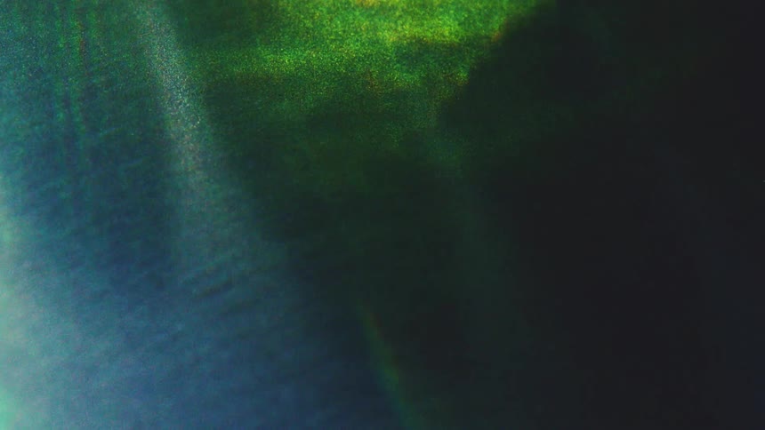 Abstract gradient in bluish and greenish tones over dark background
