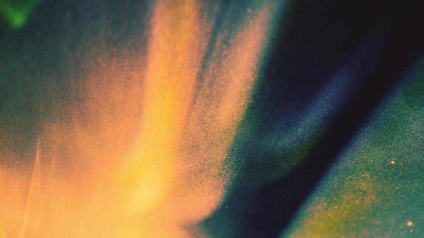 A textured overlay of warm glowing light leaks that shift across a dark background it creates a vintage cinematic atmosphere through soft gradients of orange and amber light mixed with subtle film grain