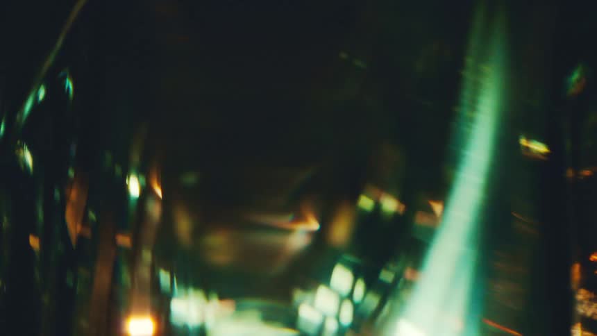 A tool spins in a dark environment illuminated by golden light