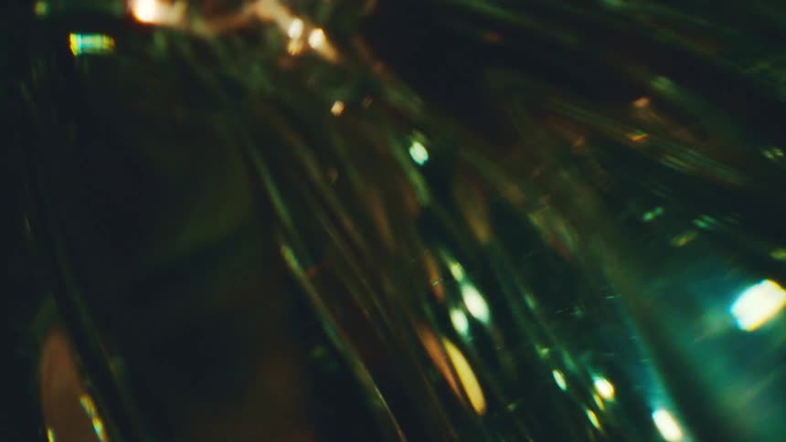 A tool spins in a dark environment illuminated by golden light