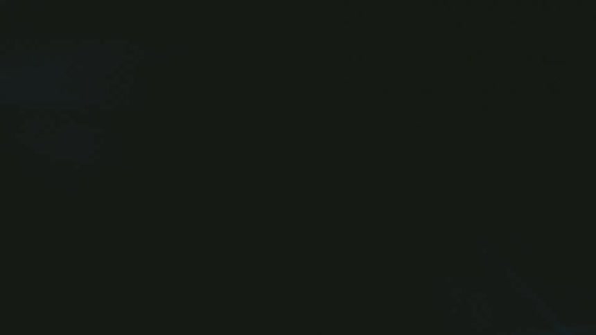 Blurred luminous shape in pinkish tone over dark background