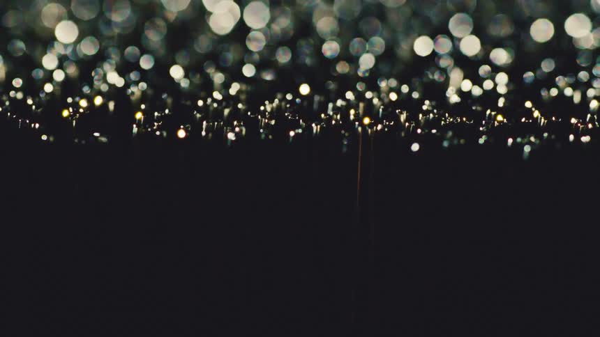 Outoffocus light dots forming circular pattern over dark background