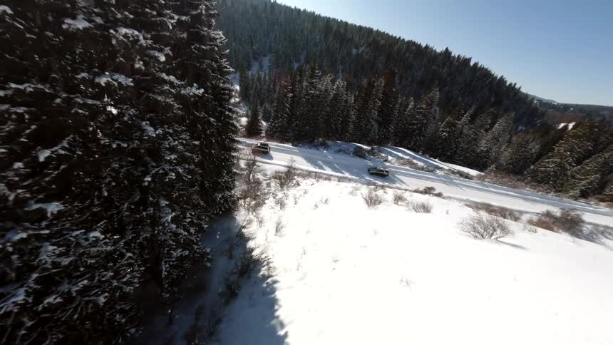 Light traffic on a snow covered forested mountain road