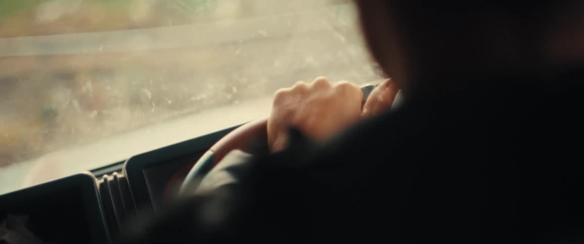 Woman steers their car across rough terrain during the daytime