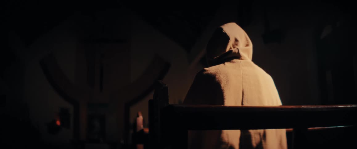 A person sitting in a pew in a church