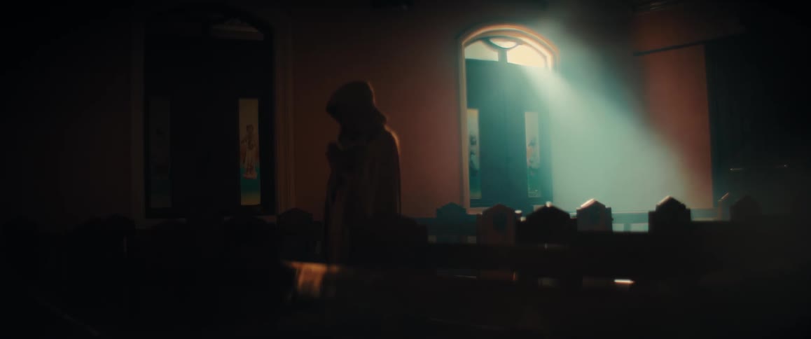 A person in a cloak walking in a church