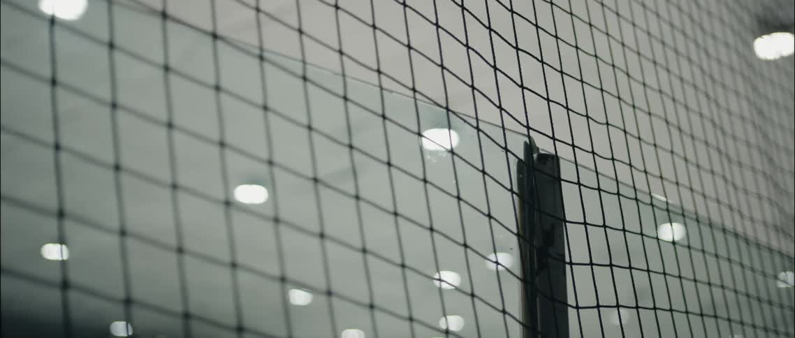 The fence runs through the warehouse