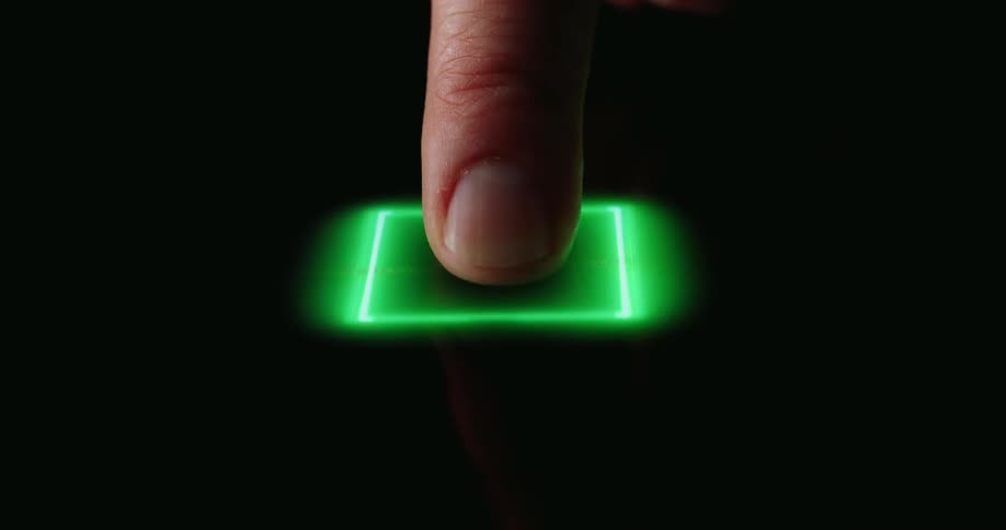 A finger presses a glowing green button embedded in a futuristic circuit board interface